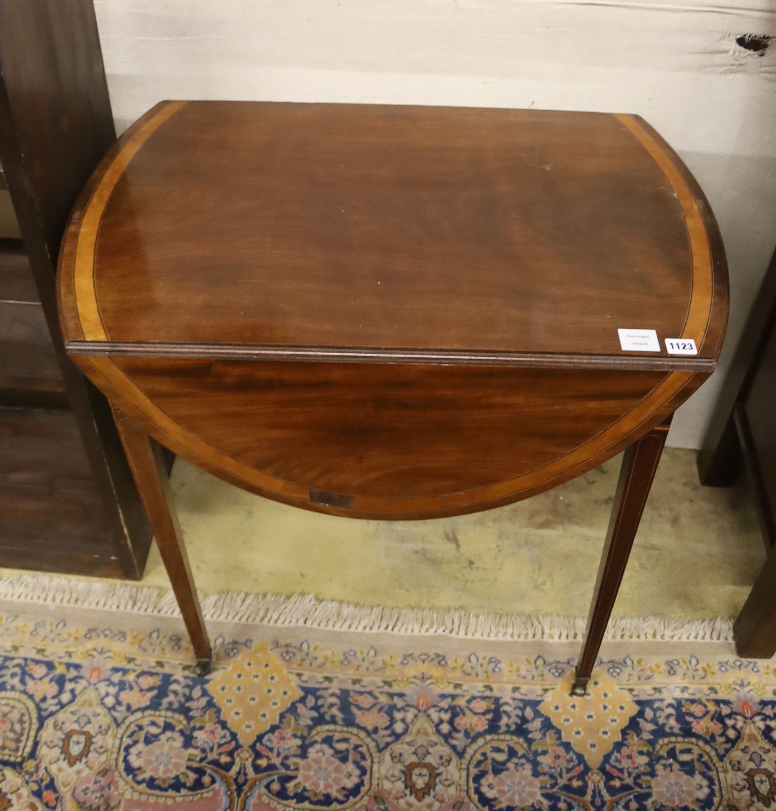A George III mahogany and satinwood banded oval topped Pembroke table, width 79cm, depth 52cm, height 74cm